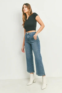 Woman in black crop top and white boots showcasing women’s boho chic sailor pocket wide leg jeans