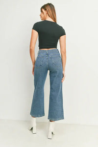Woman in a black crop top highlights women’s boho chic sailor pocket wide leg jeans