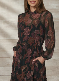 Woman in black floral bohemia maxi dress with pockets and mock neck for LOST + WANDER