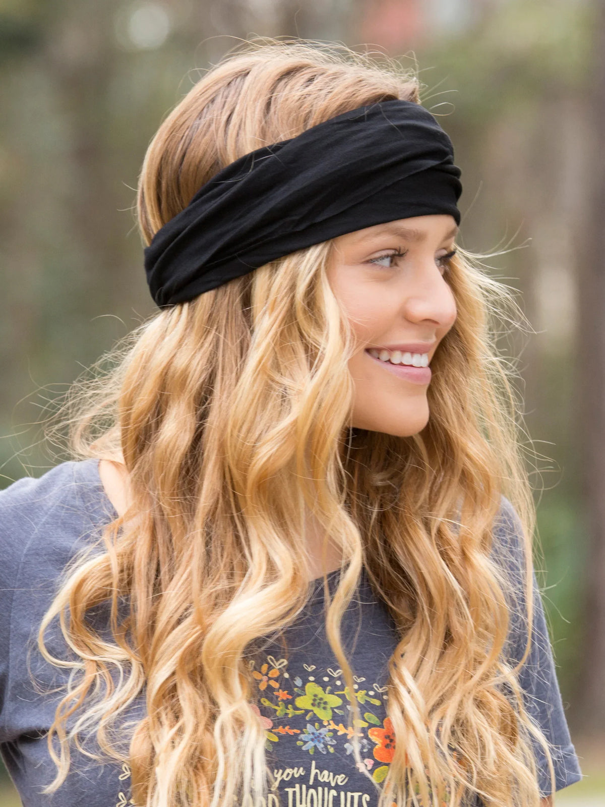 Woman with long hair wearing a black boho bandeau headband for stylish looks