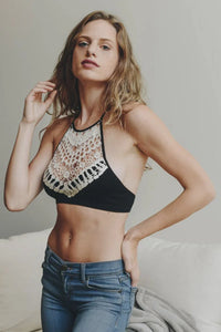 Woman in a black top and jeans showcasing Crochet Lace High Neck Bralette