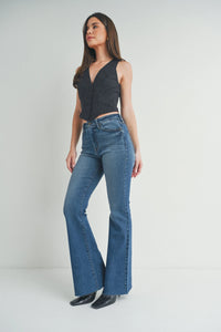 Woman in a black top and jeans showcasing Mid Rise Straight Bootcut Jeans in boho style