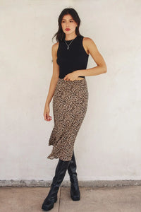 Woman in black top and leopard animal print midi skirt, size small