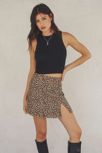 Woman in black top showcasing SEEING SPOTS Leopard Animal Mini Skirt from Shop Daisy