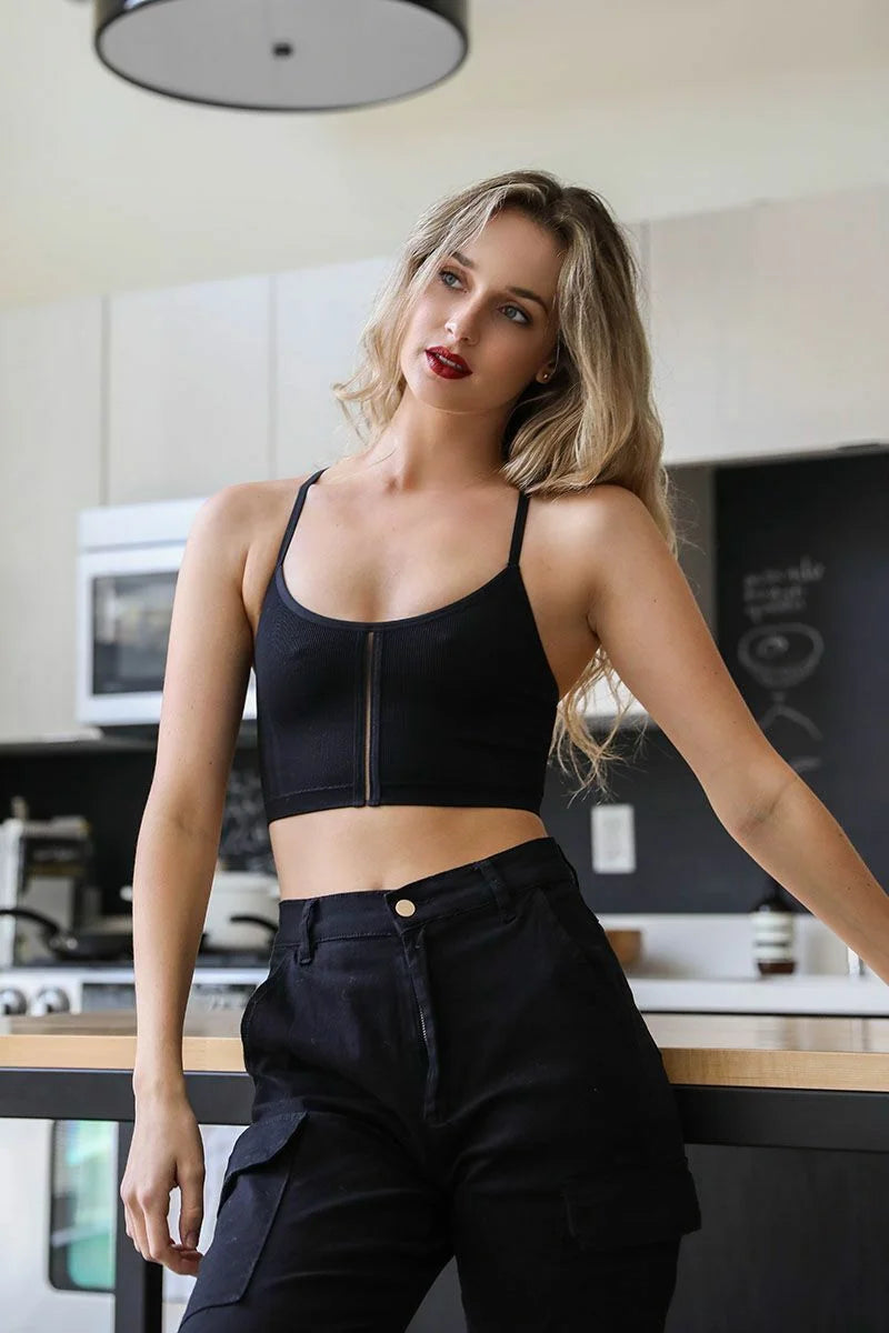 Woman in a black top and pants wearing a Seamless Longline Pullover Boho Bralette