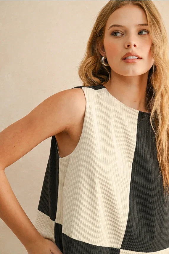 Woman wearing a black and white checkered corduroy color block mini dress