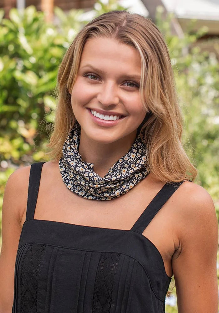 Woman in black top with black and cream floral boho bandeau headband styled elegantly