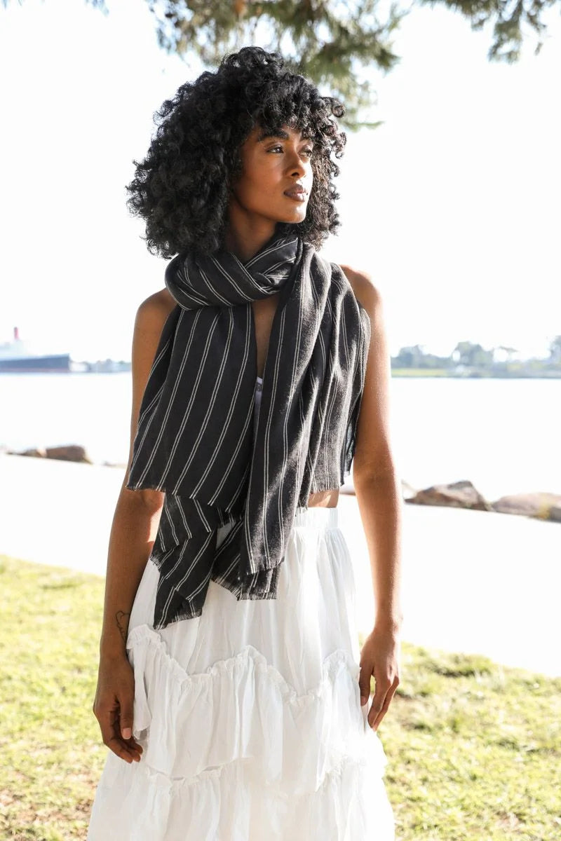 Woman wearing a Pencil Stripe Double Weave Scarf with black and white stripes