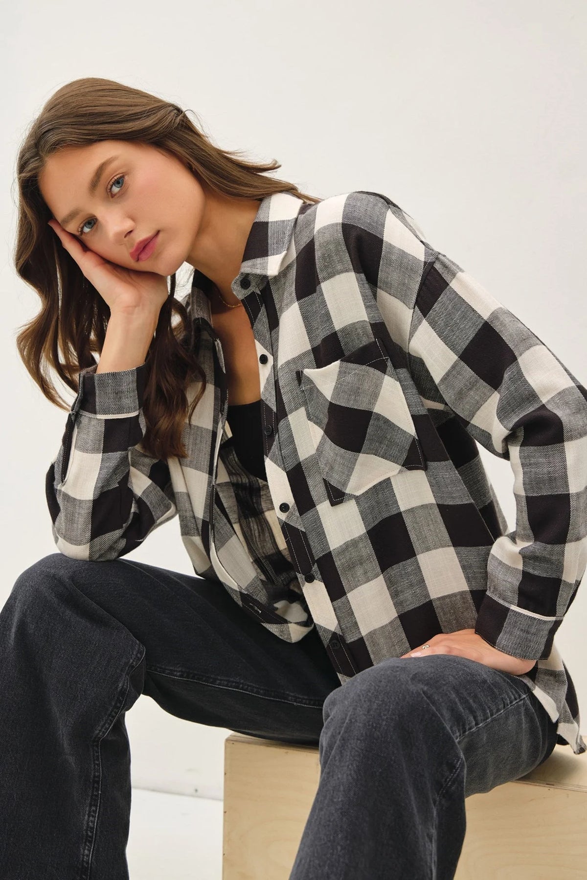 Woman in a black and white check flannel shirt showcasing the Soft Buffalo Check style