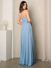 Woman in a blue sleeveless surplice tie maxi dress featuring a back tie design