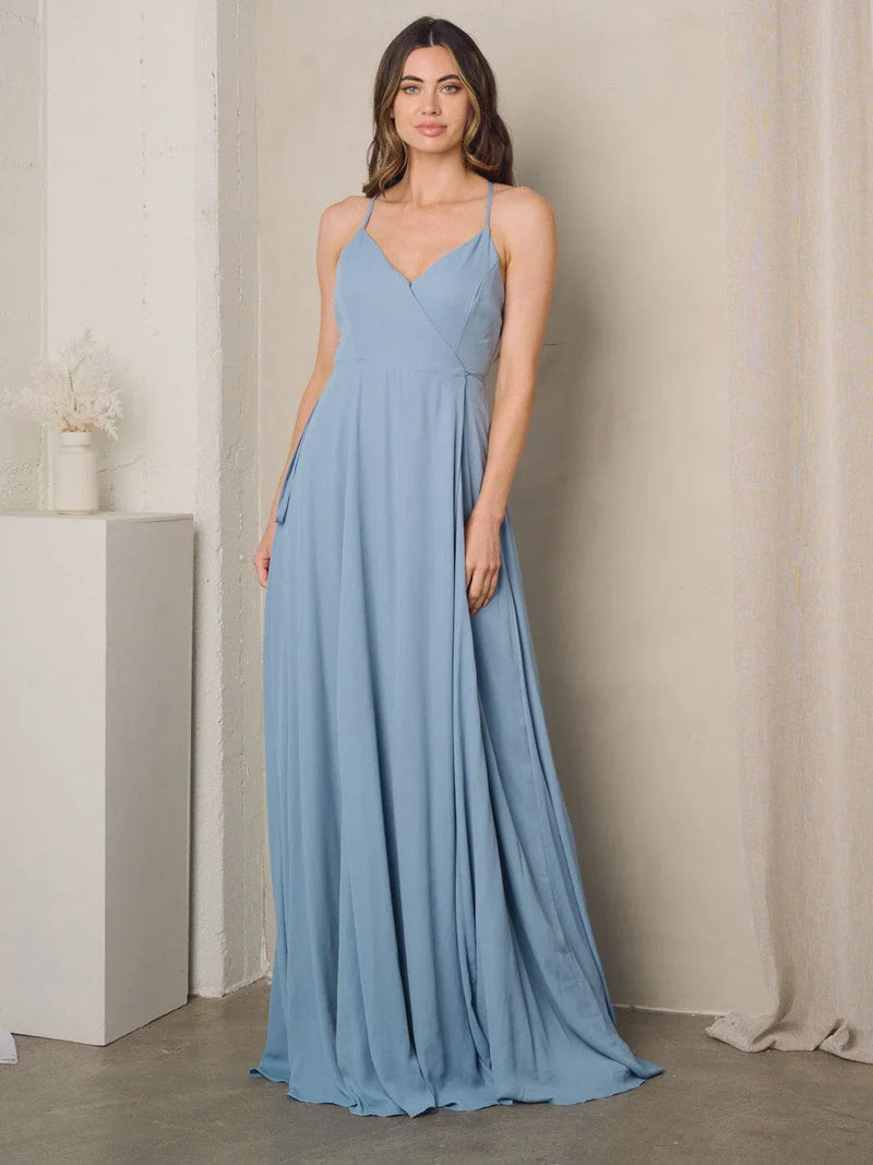 Woman in a blue sleeveless surplice tie maxi dress showcasing elegant style