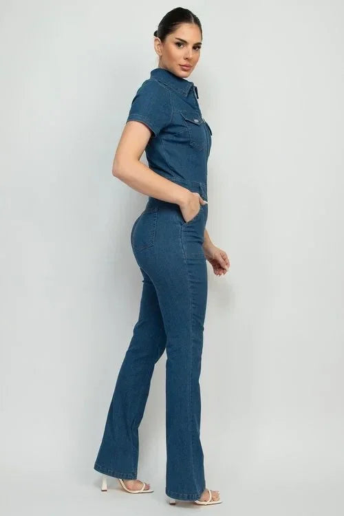 Woman in a blue woven denim jumpsuit with short sleeves and flared pants