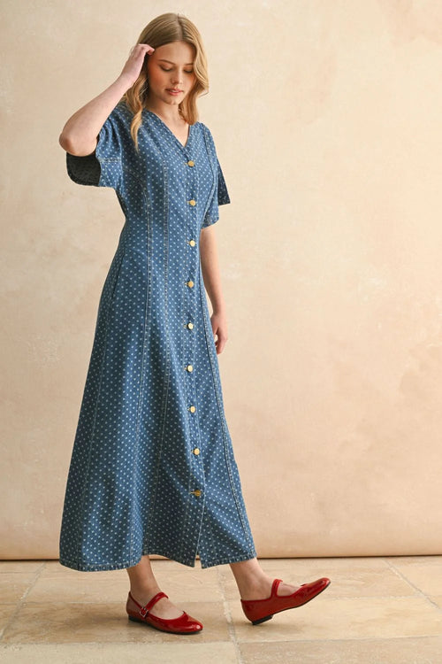 Woman modeling a blue dot print midi dress with short sleeves and red Mary Jane flats for women’s boho chic clothing at Shop Daisy
