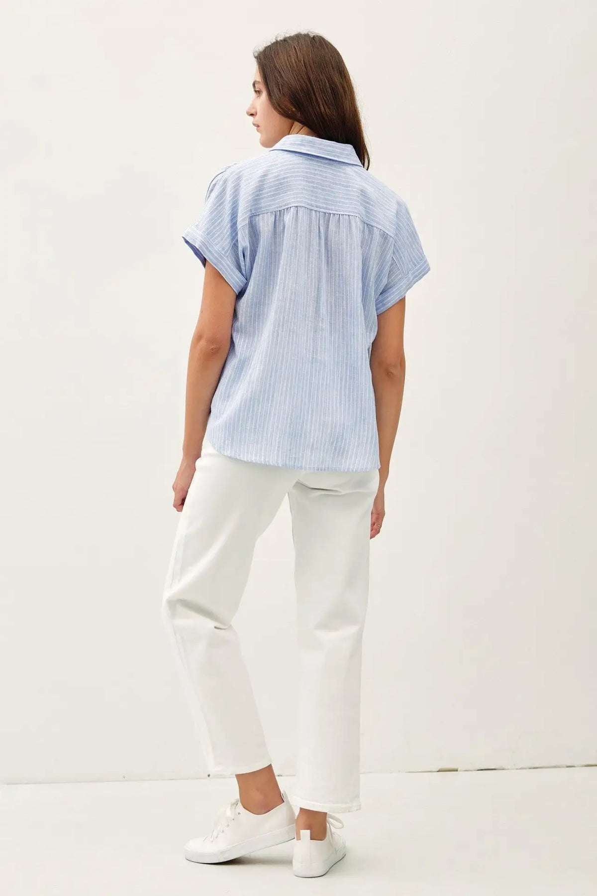 Woman wearing shoulder shirring stripe top in women’s boho chic clothing from Shop Daisy