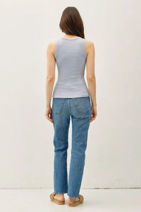 Woman wearing a dyed round neck tank top in blue with jeans for a casual look