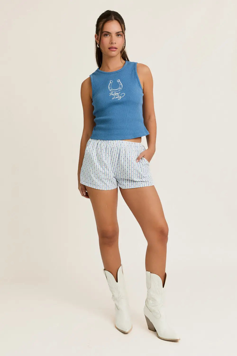 Woman wearing embroidery detail rib tank top in blue, striped shorts, and white cowboy boots at Shop Daisy Lane