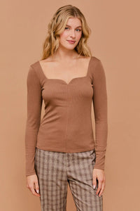 Woman in brown long sleeve sweetheart rib top showcasing elegant design and comfort