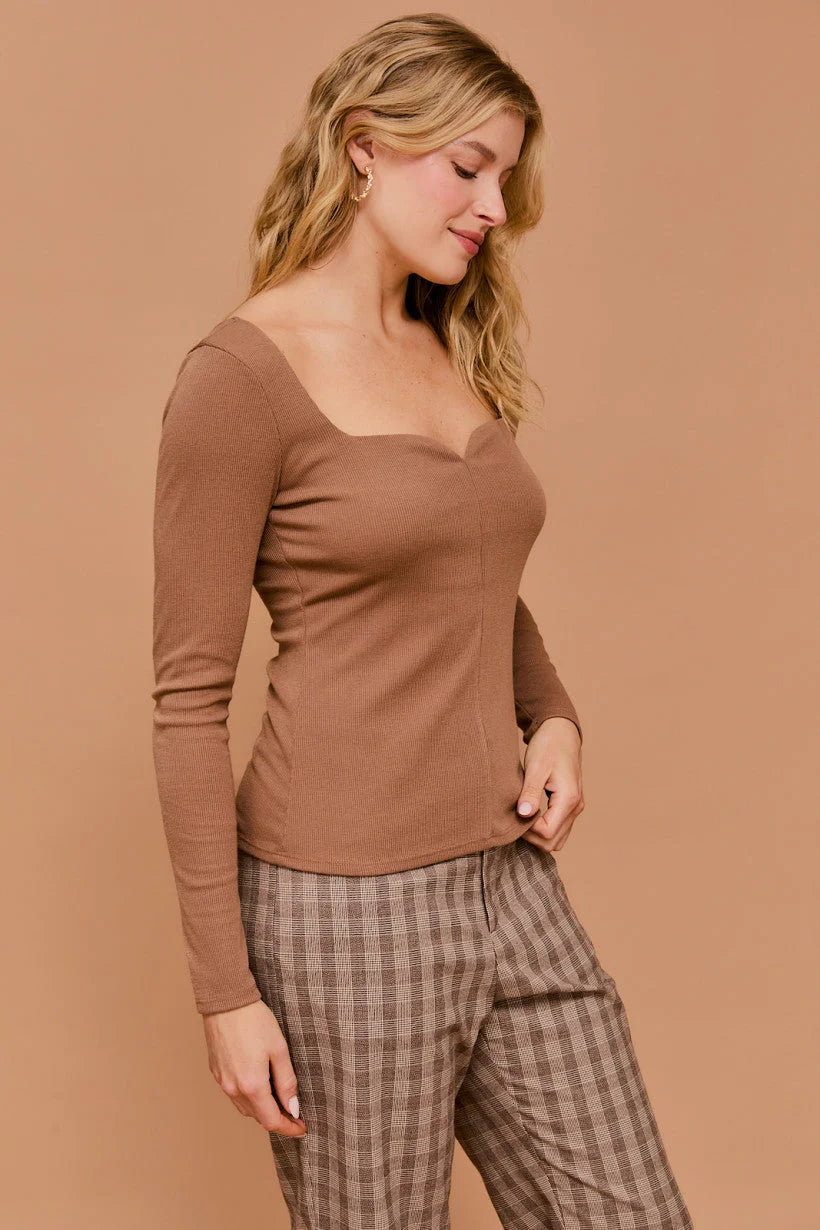 Woman in brown long sleeve sweetheart rib top with plaid pants for stylish outfits