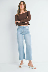 Woman in brown off-shoulder top and light blue flowy SLIM WIDE LEG DENIM, perfect for free spirit style