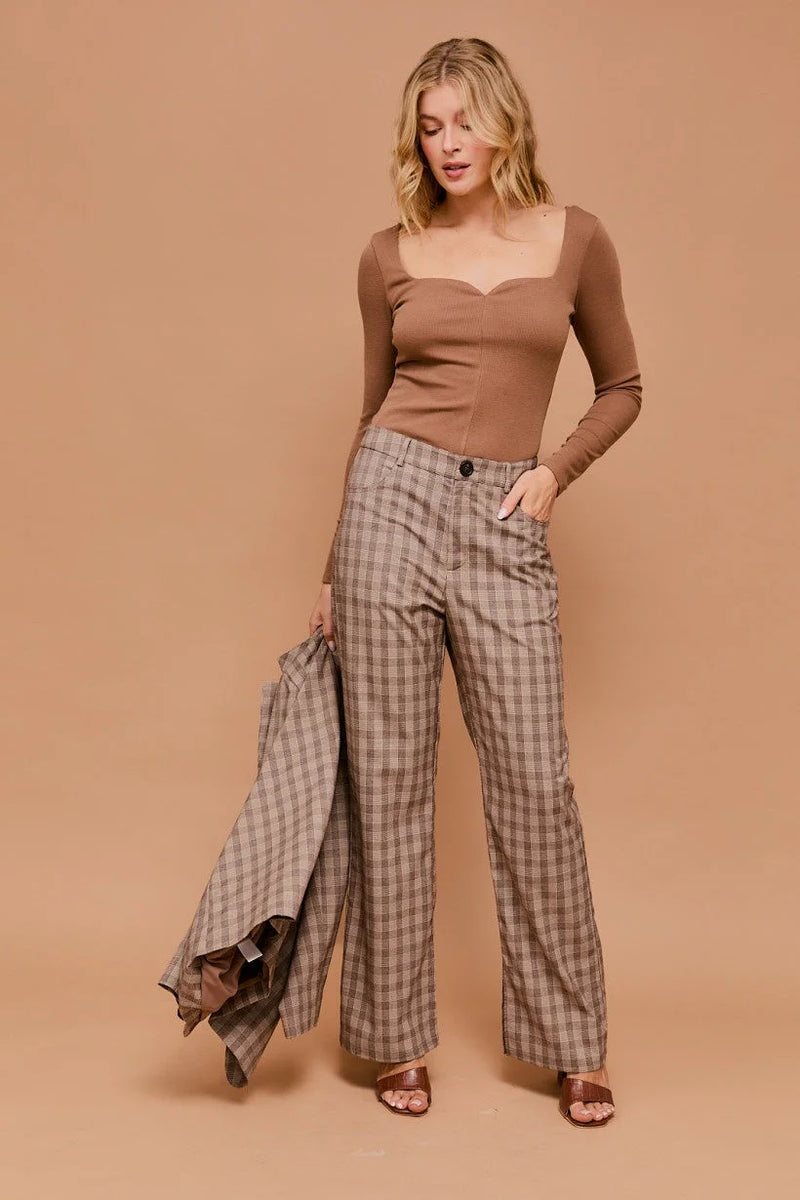 Woman in long sleeve sweetheart rib top and wide-leg plaid pants