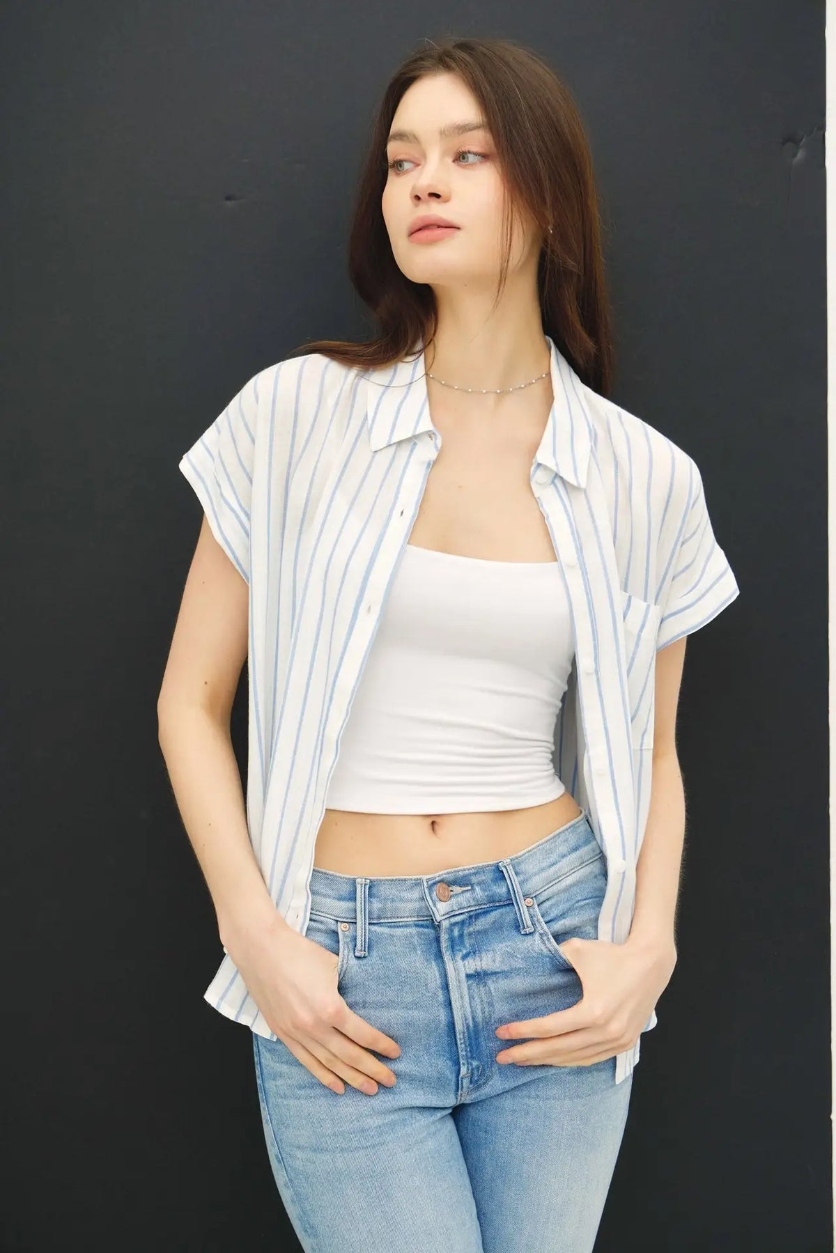 Woman in casual short sleeve striped shirt illustrating stylish summer fashion
