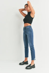 Woman in casual attire poses with arms raised, showcasing Slim Straight Distress Denim