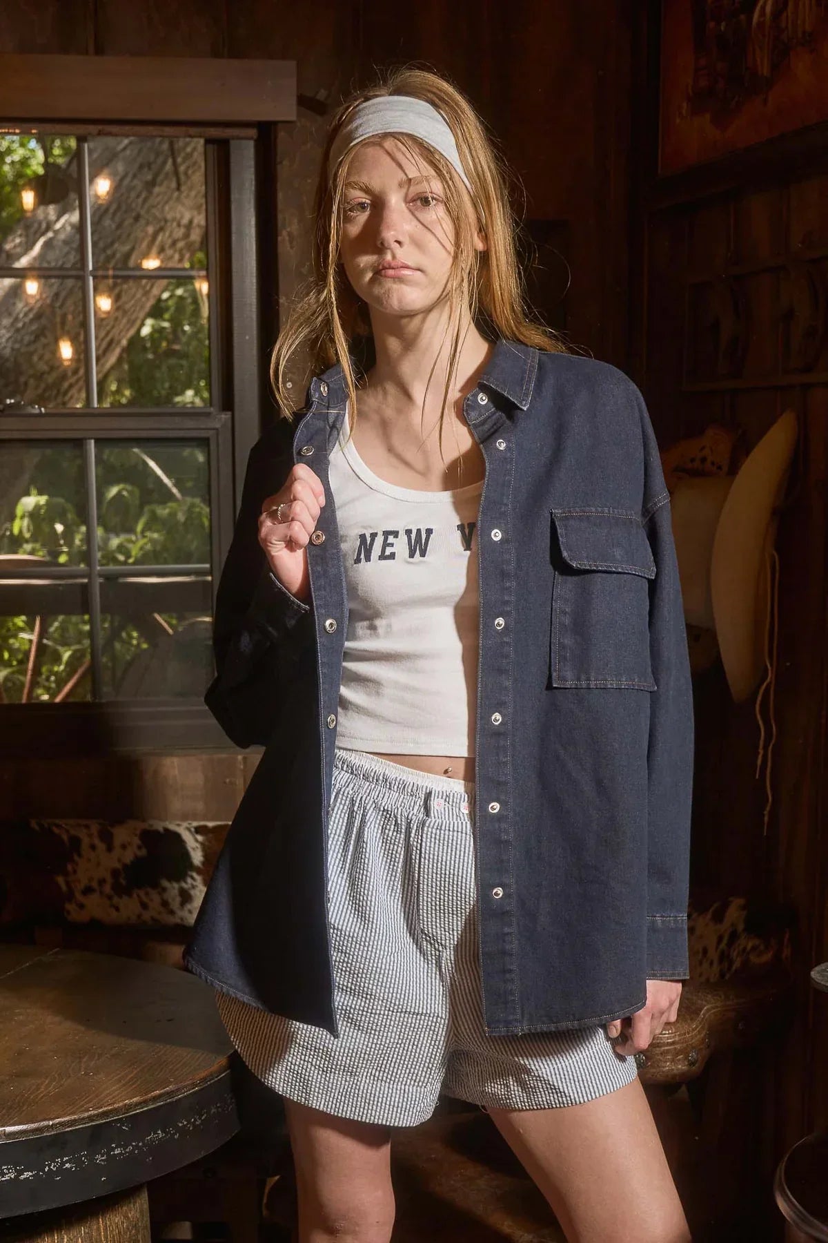 Woman wearing dark denim casual attire showcasing women’s boho chic clothing at Shop Daisy