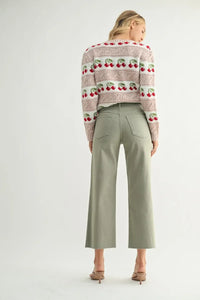 Woman in cherry-patterned sweater and wide leg denim pants showcasing NAUTICAL HIGH RISE WIDE LEG DENIM