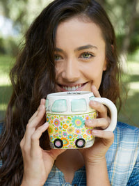 Smiling woman with hand sculpted FOLK ART COFFEE MUG - DAISY THE VAN in boho style