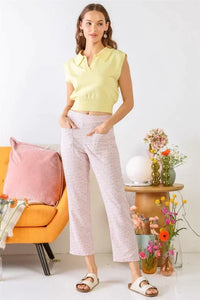 Woman in Chamomile Print High Waist Pants with Flowers by Couch in Boho Style