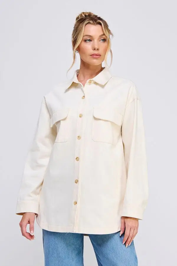 Woman wearing a cream-colored oversized denim twill shacket, stylish twill shacket for women
