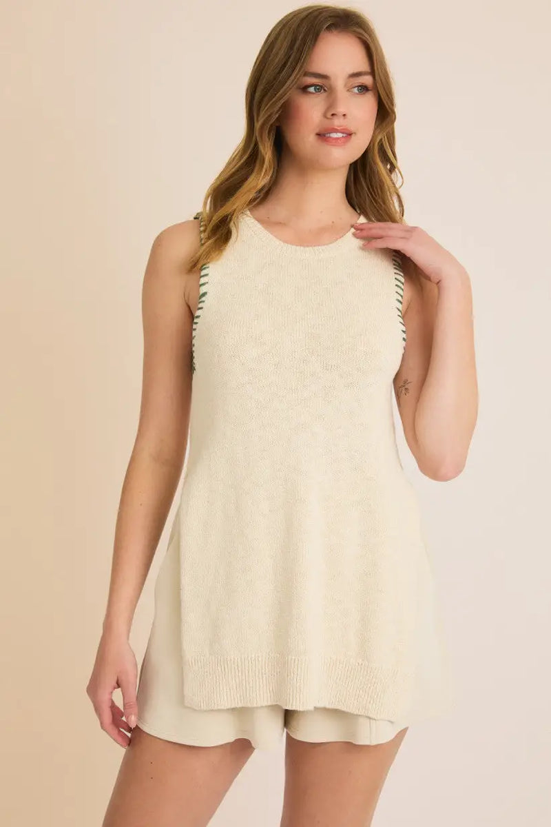 Woman modeling a cream-colored round neck sleeveless knit tank top and shorts set