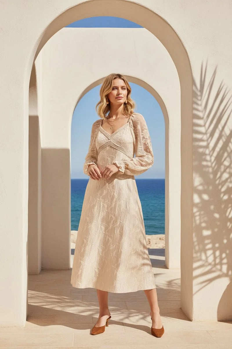 Woman wearing a cream lace jacquard maxi dress with midi skirt and brown heels