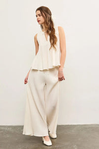 Woman wearing cream-colored elastic waist wide leg pants, stylish wide leg trousers