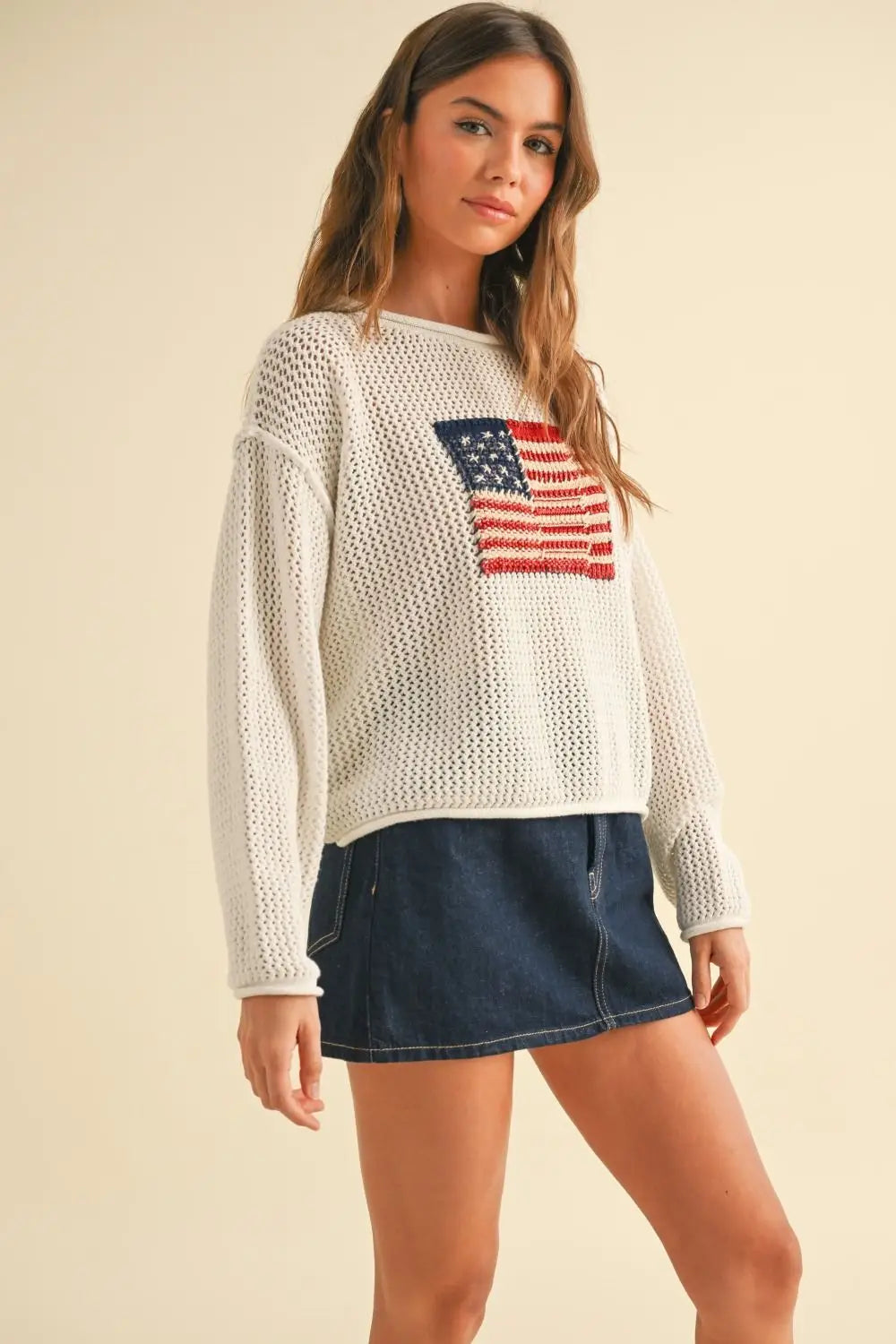 Women wearing cream-colored flag knitted sweater top in women’s boho chic clothing style