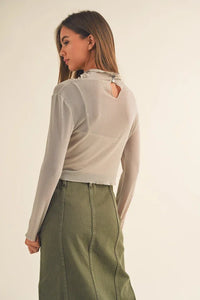 Woman in cream sweater and olive green skirt, showcasing women’s boho chic clothing