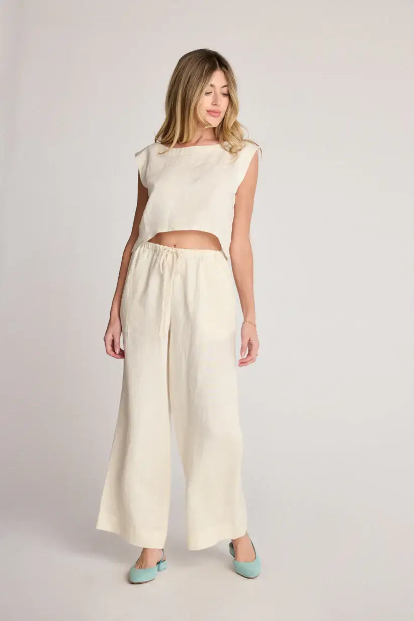 Woman in a cream-colored two-piece boho chic outfit from Shop Daisy Women’s Boho Clothes