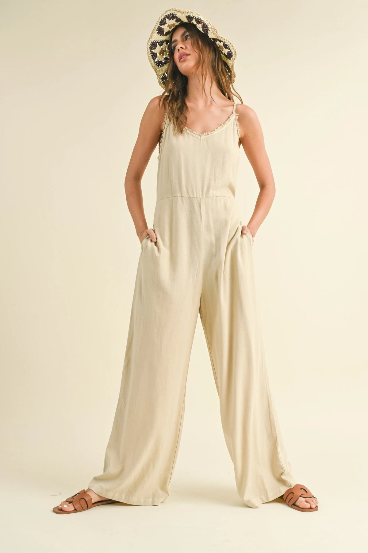 Woman in cream wide-leg DYE & WASH JUMPSUIT with floral crown, boho style, measurements available