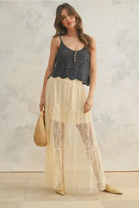 Woman in a crochet top and tiered lace maxi skirt embodying women’s boho chic clothing