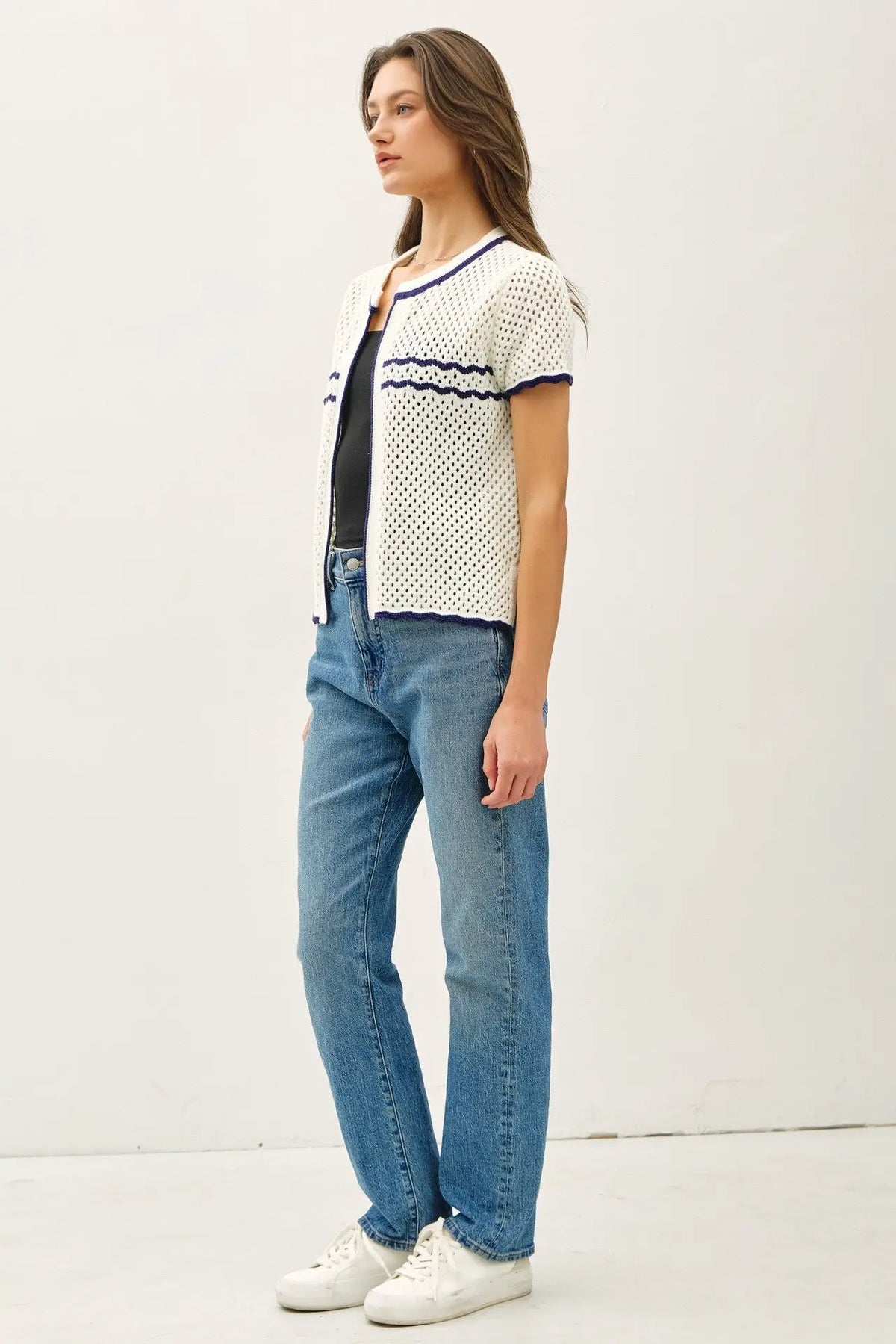 Woman wearing a crochet knit open cardigan and jeans, ideal womens boho clothes