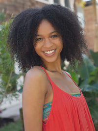 A woman with curly hair smiles while wearing the FULL BOHO Bandeau Headband