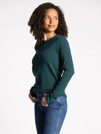 Woman with curly hair in a dark green MICRO RIBBED ULTRA SOFT LONG SLEEVE TOP