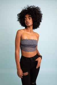 Woman with curly hair modeling a Wide Lace Bandeau with detachable straps