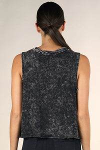 Woman from behind wearing a dark acid-wash cotton muscle tee and dark pants
