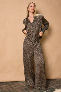 Woman wearing dark brown patterned sand pull drawstring pants with relaxed fit