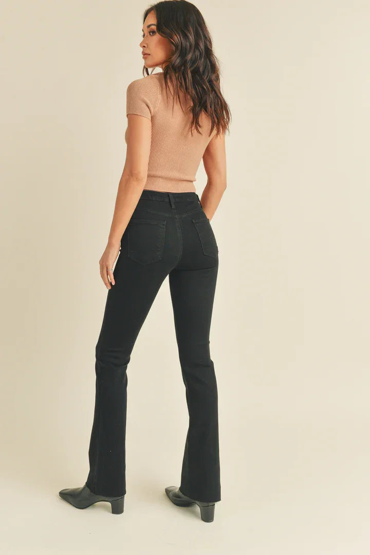 Woman in flowy dark flared jeans and beige sleeveless top from SLIM BOOTCUT WITH SCISSOR CUT