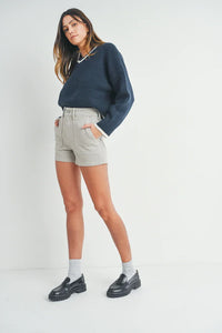 Woman in dark sweater and light shorts, showcasing HR Utility Cargo Short for a free spirit look