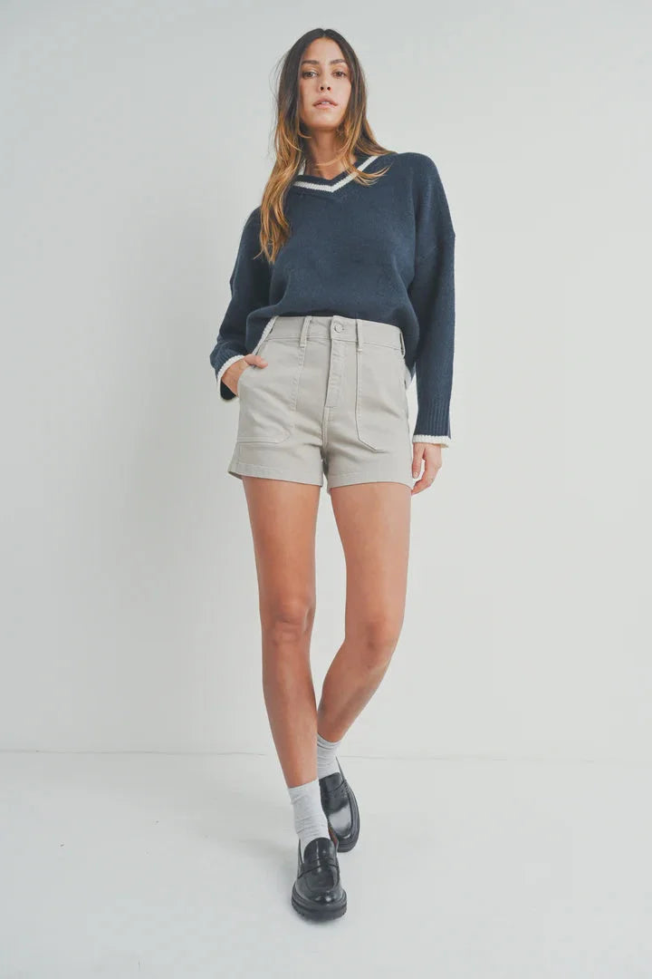 Woman in dark sweater and light shorts showcasing Boho HR Utility Cargo Short