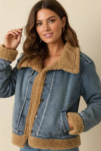 Woman wearing a supply Henrietta jacket with denim and brown sherpa lining