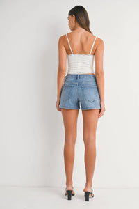 Woman wearing PATCH POCKET SHORT denim shorts with relaxed fit and patch pockets